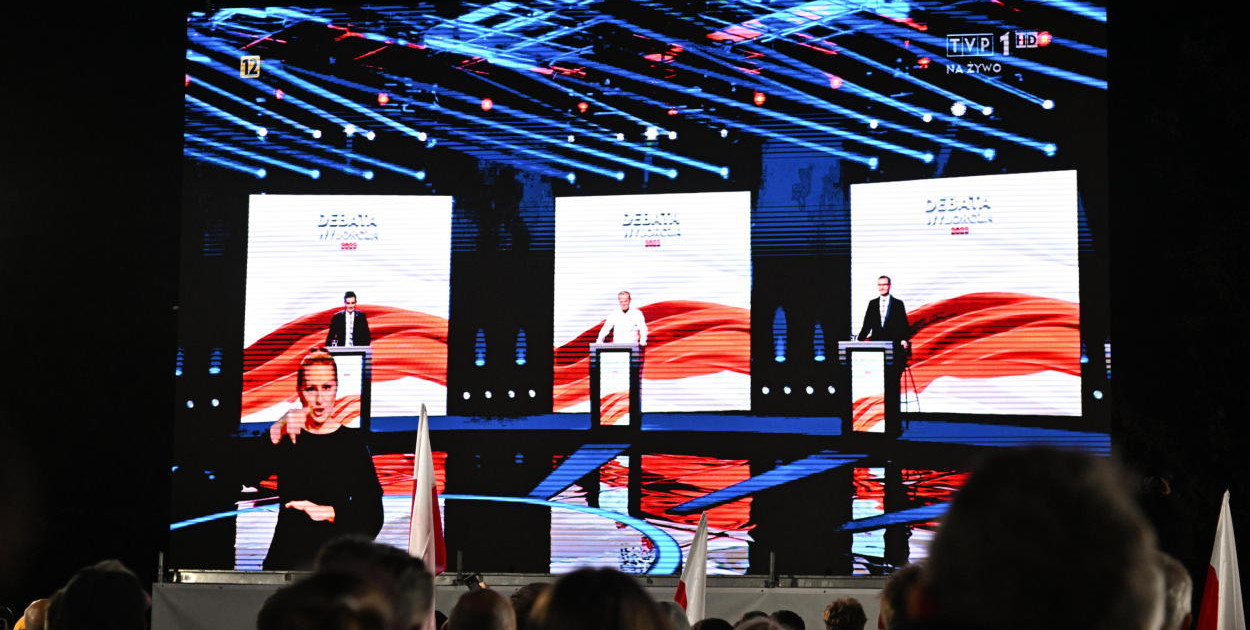 Debata w TVP głównie między M. Morawieckim i D. Tuskiem; w tle wazon od Putina i z